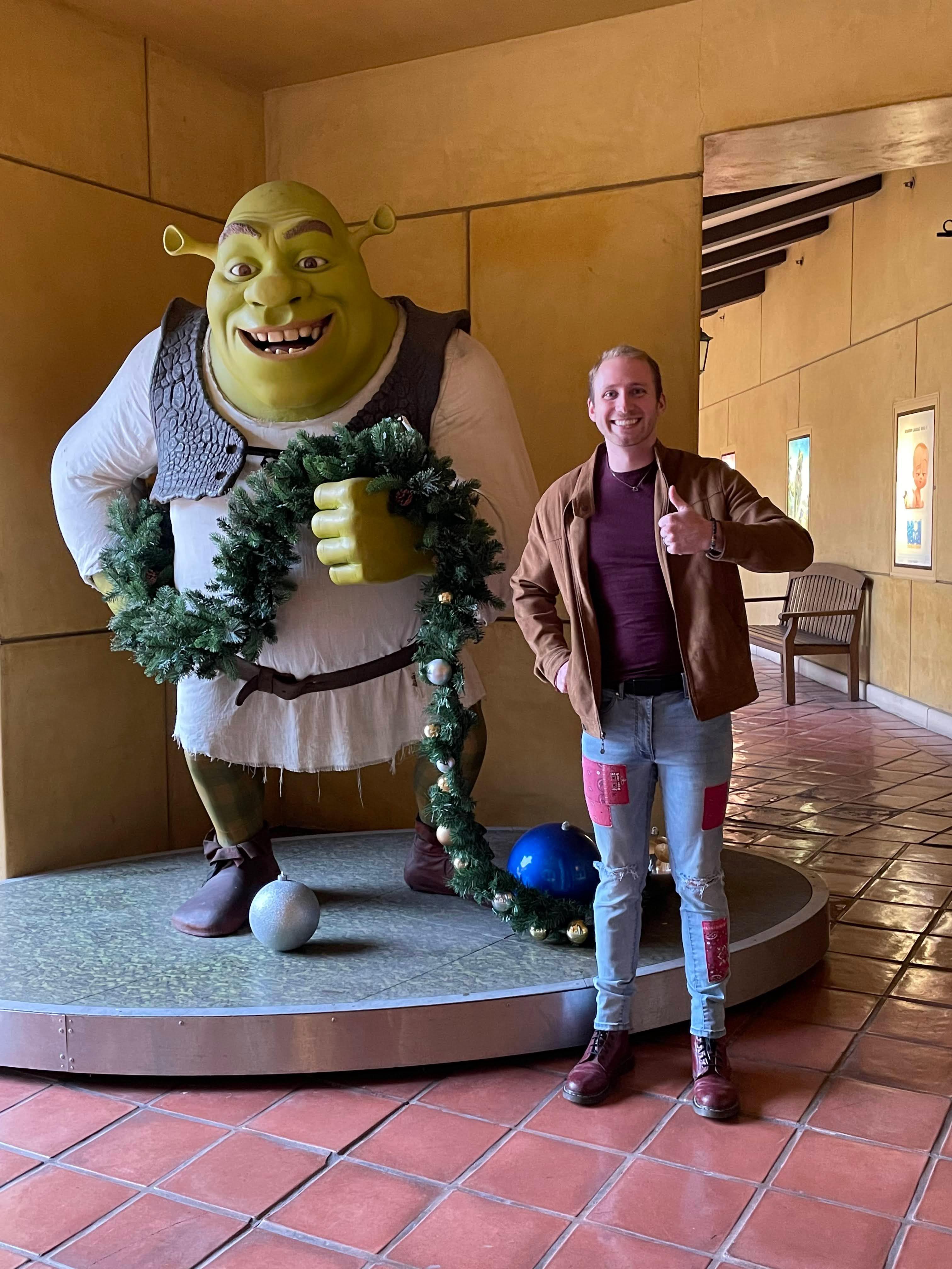 Joey strikes a pose with Shrek at DreamWorks